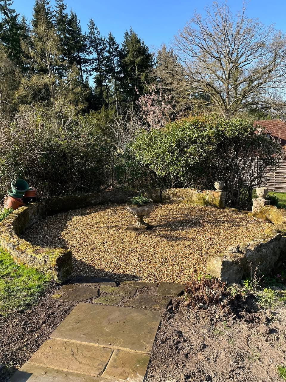 Circular gravel area with decorative stone edging