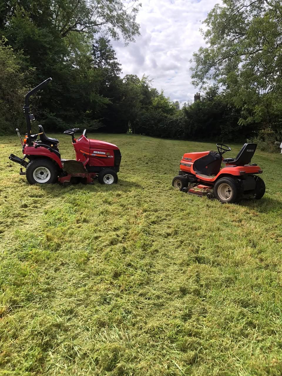 Two professional ride-on mowers on freshly cut paddock