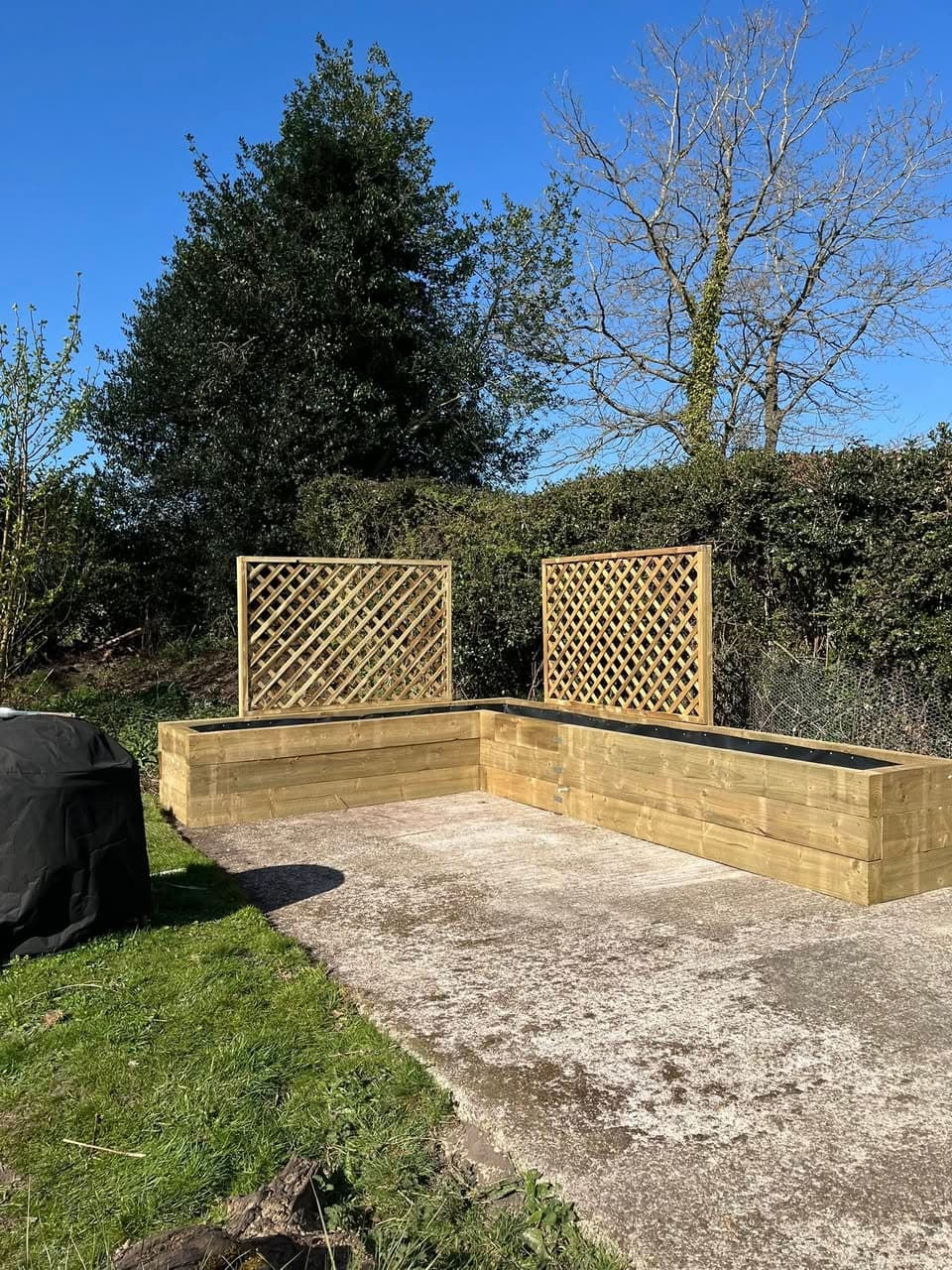 L-shaped raised bed with pressure-treated timber sleepers